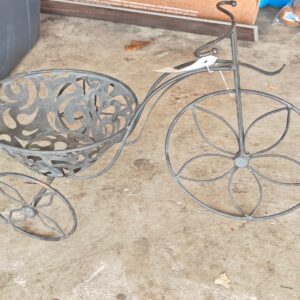 A vintage tricycle plant stand