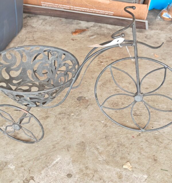 A vintage tricycle plant stand